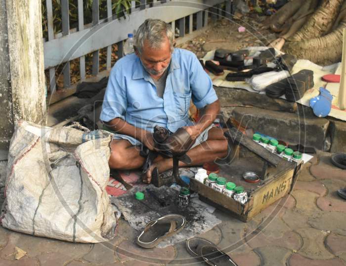 A cobbler repairing shoes.