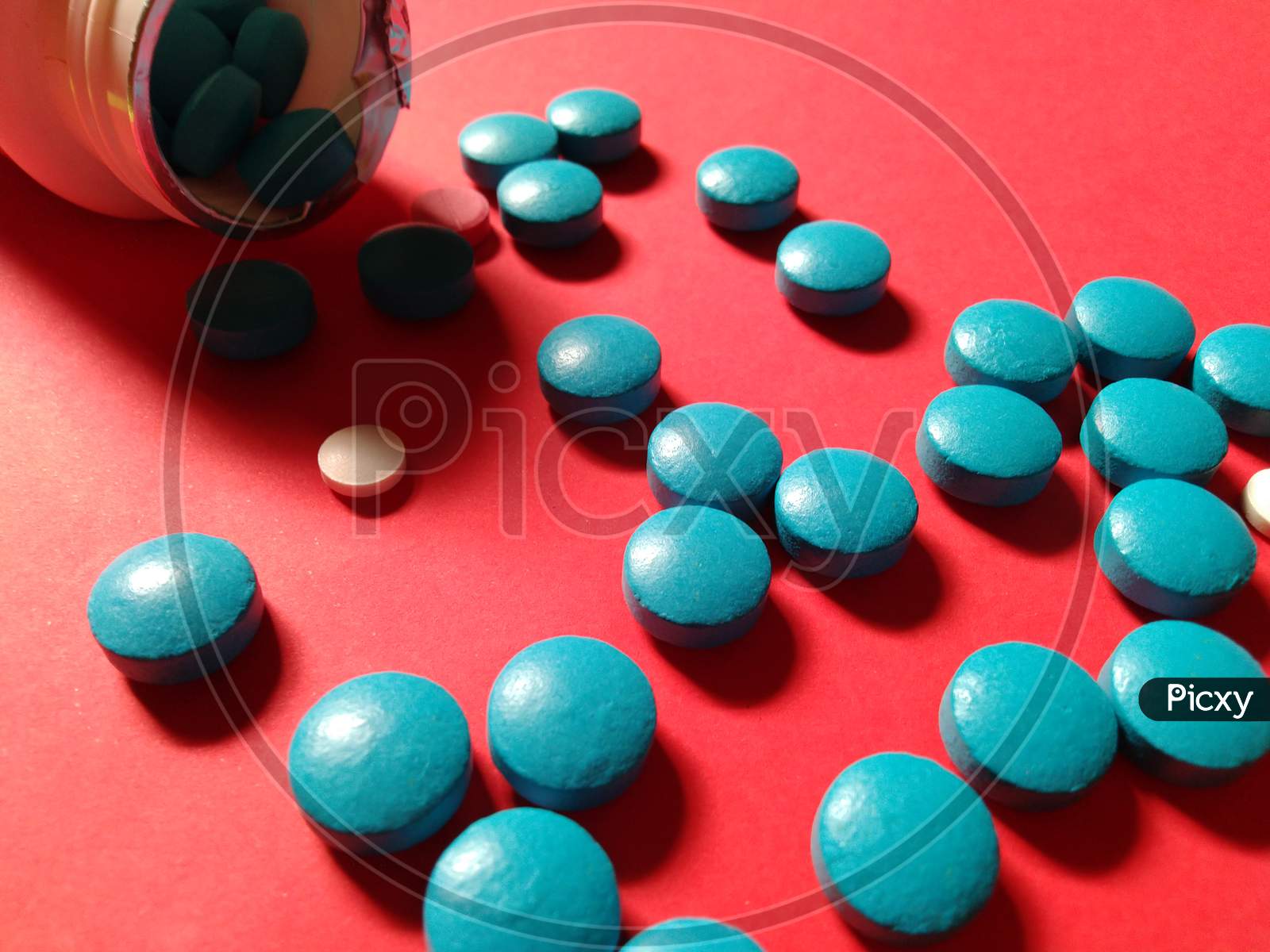 Medicine tablets on red background