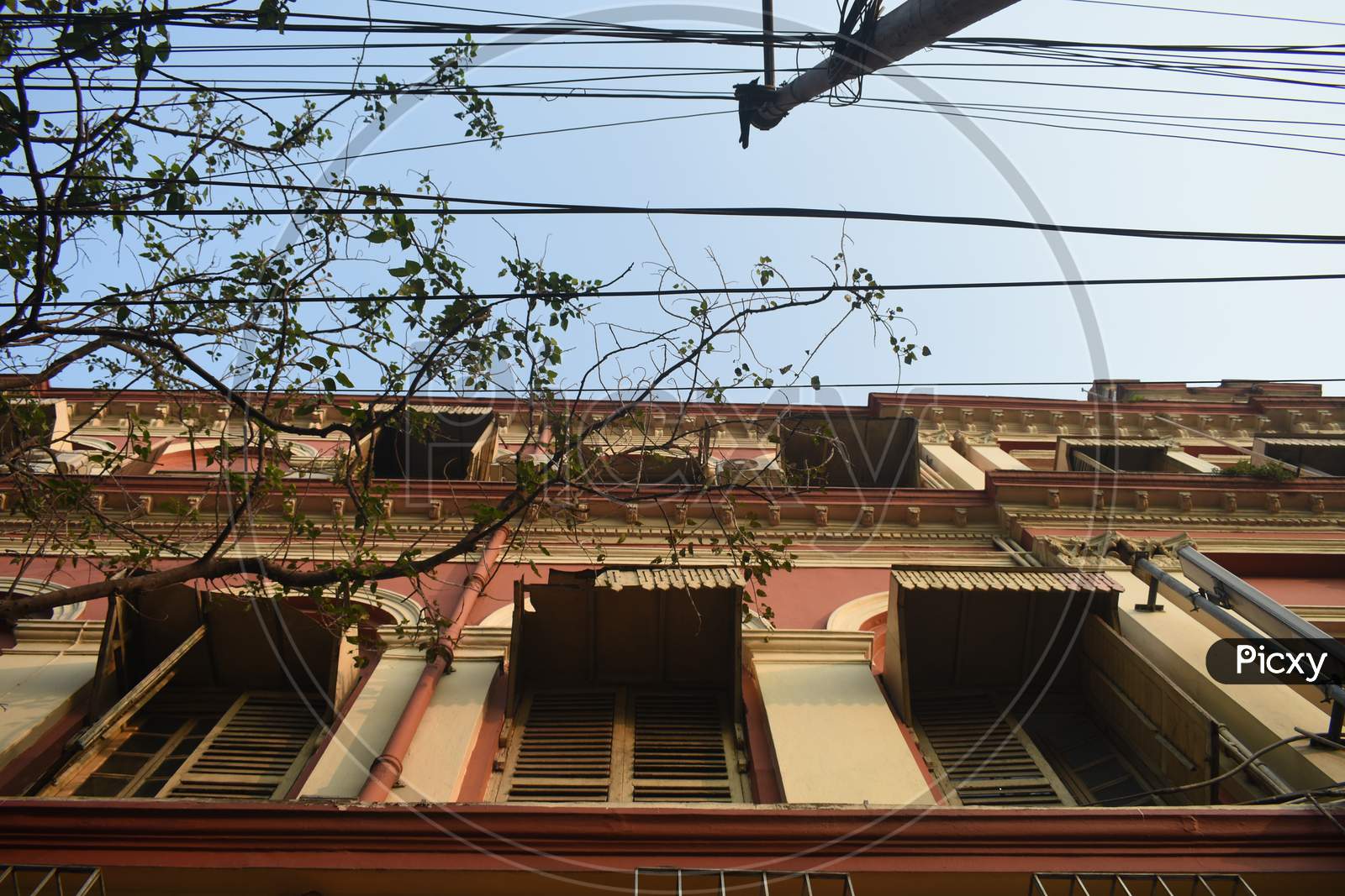 The wires near a building.