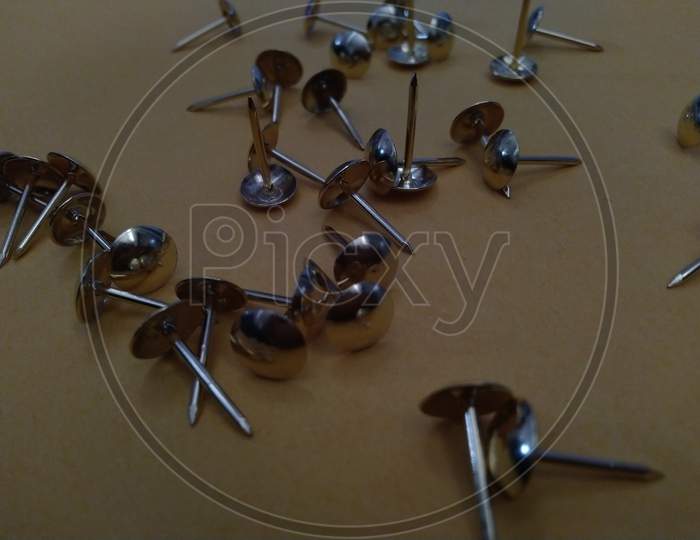 small paper pins on ground