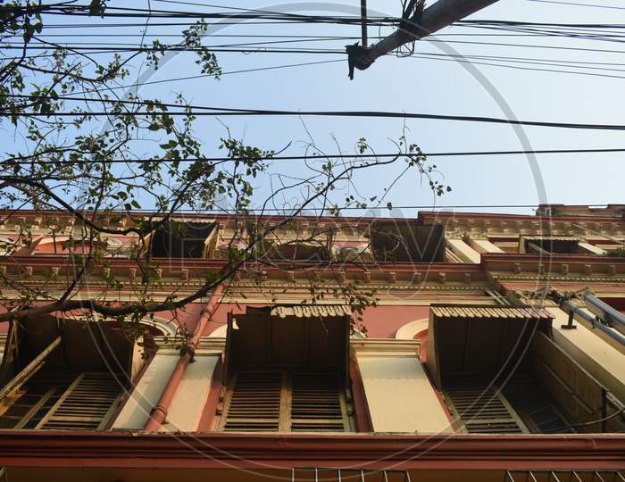 The wires near a building.