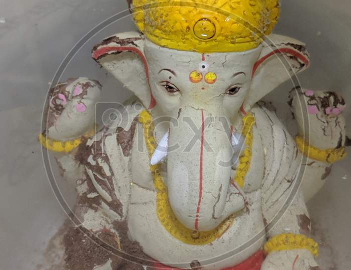 Ganesh idol made of soil visarjan at home in bucket.