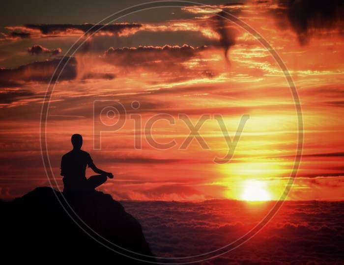 Meditation - Mindfulness - Person Meditating At Sunset Over The Clouds