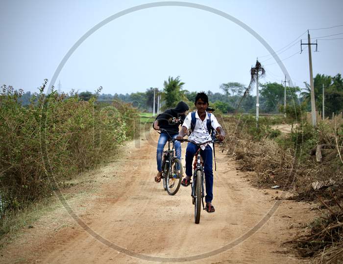 Village school kids riding bicycles.