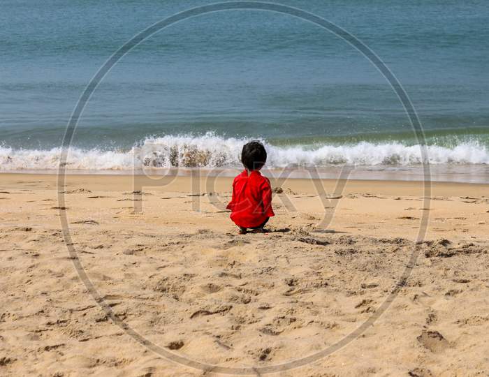 Back view of a child on the beach