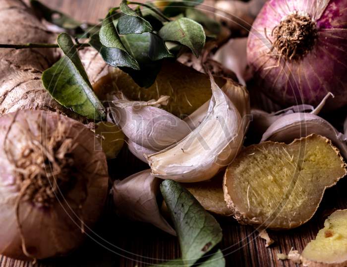 View Of Commonly Used In Ingredient (Garlic, Ginger, Onion And Curry Leaves) In South Indian Cooking. Foods That Help Boost Immunity In Natural Way.