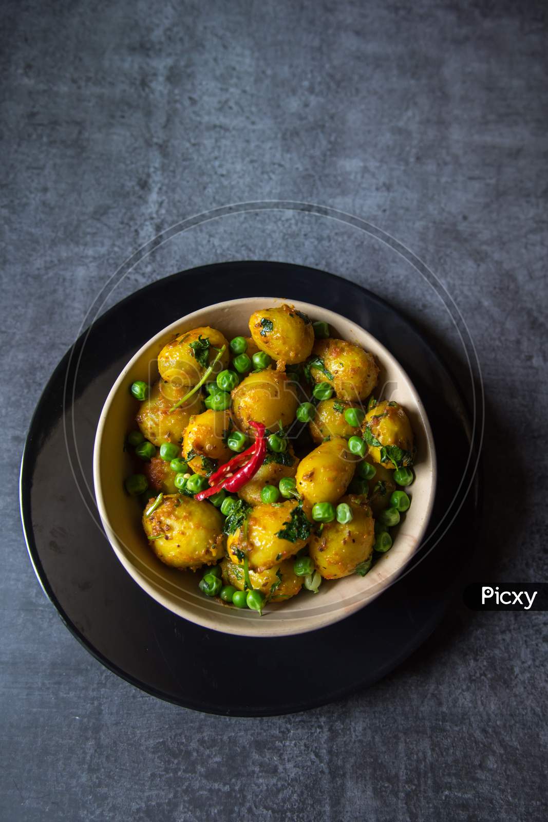 Indian dum aloo or potatoes cooked in slow fire in a bowl.