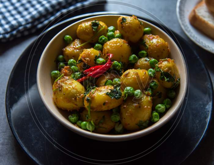 Indian food item dum aloo or potatoes cooked in slow fire in a bowl.