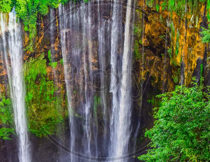 TUMPAK SEWU.Panoramic beautiful deep forest waterfall in Indonesia