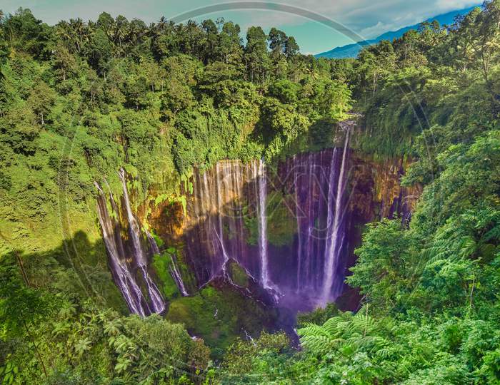 TUMPAK SEWU.Panoramic beautiful deep forest waterfall in Indonesia