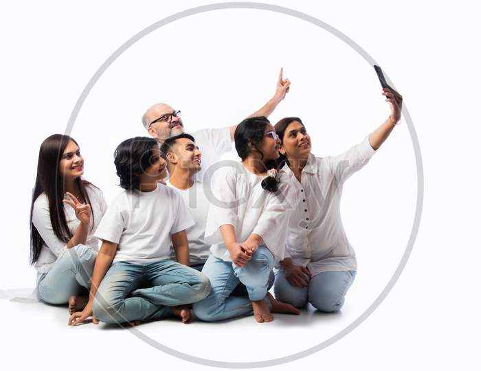 Indian Asian Multigenerational Family Using Smartphone For Selfie Or Video Calling