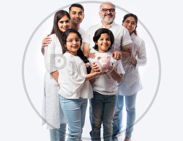 Indian Family With Piggy Bank Standing Or Sitting Isolated Against White