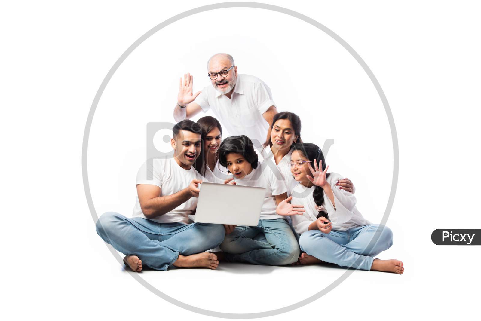Happy Indian Family Shopping Online Using Laptop And Credit Or Debit Card While Sitting Isolated