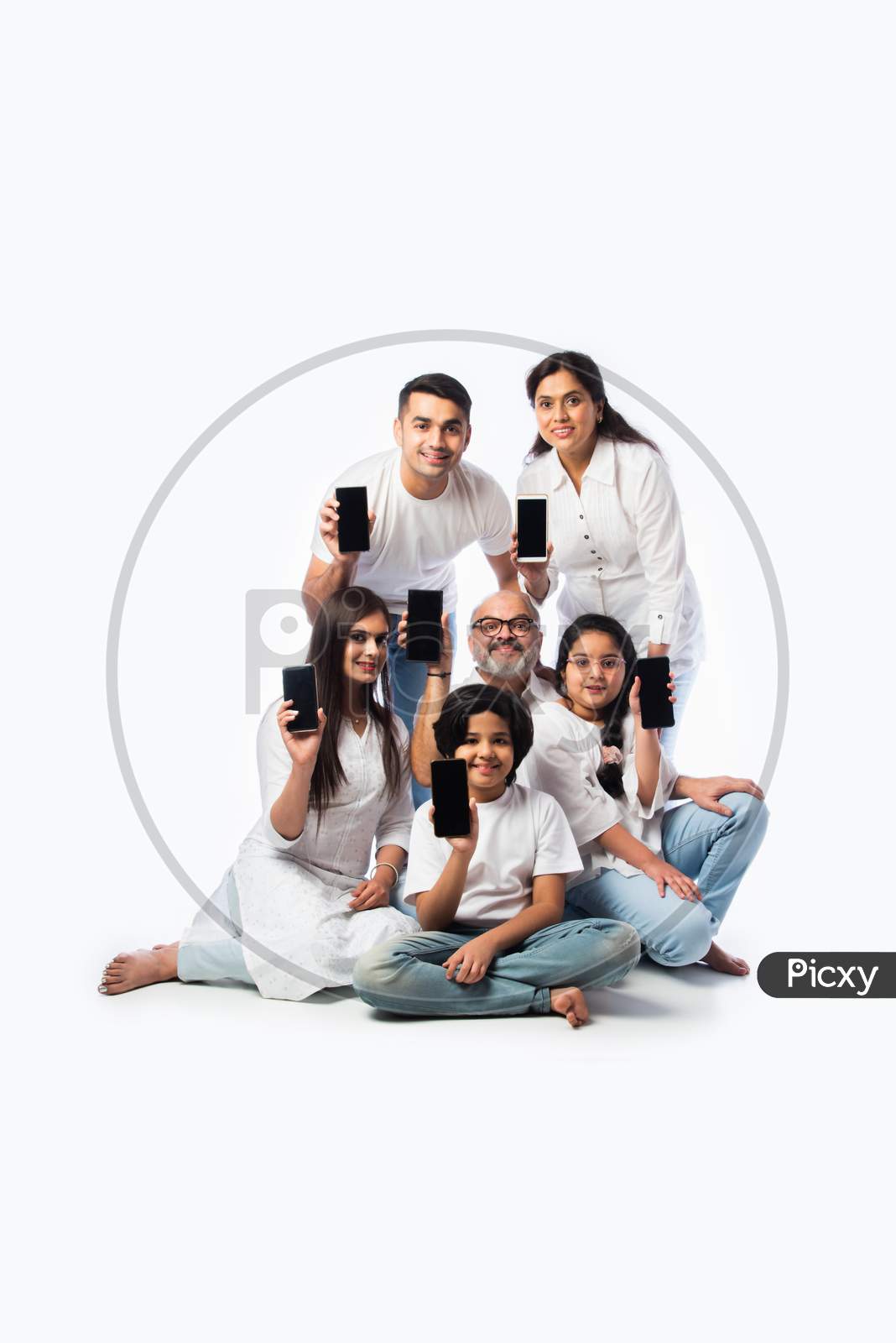 Asian Indian Family Of Six Showing Blank Or Empty Smartphone Screen