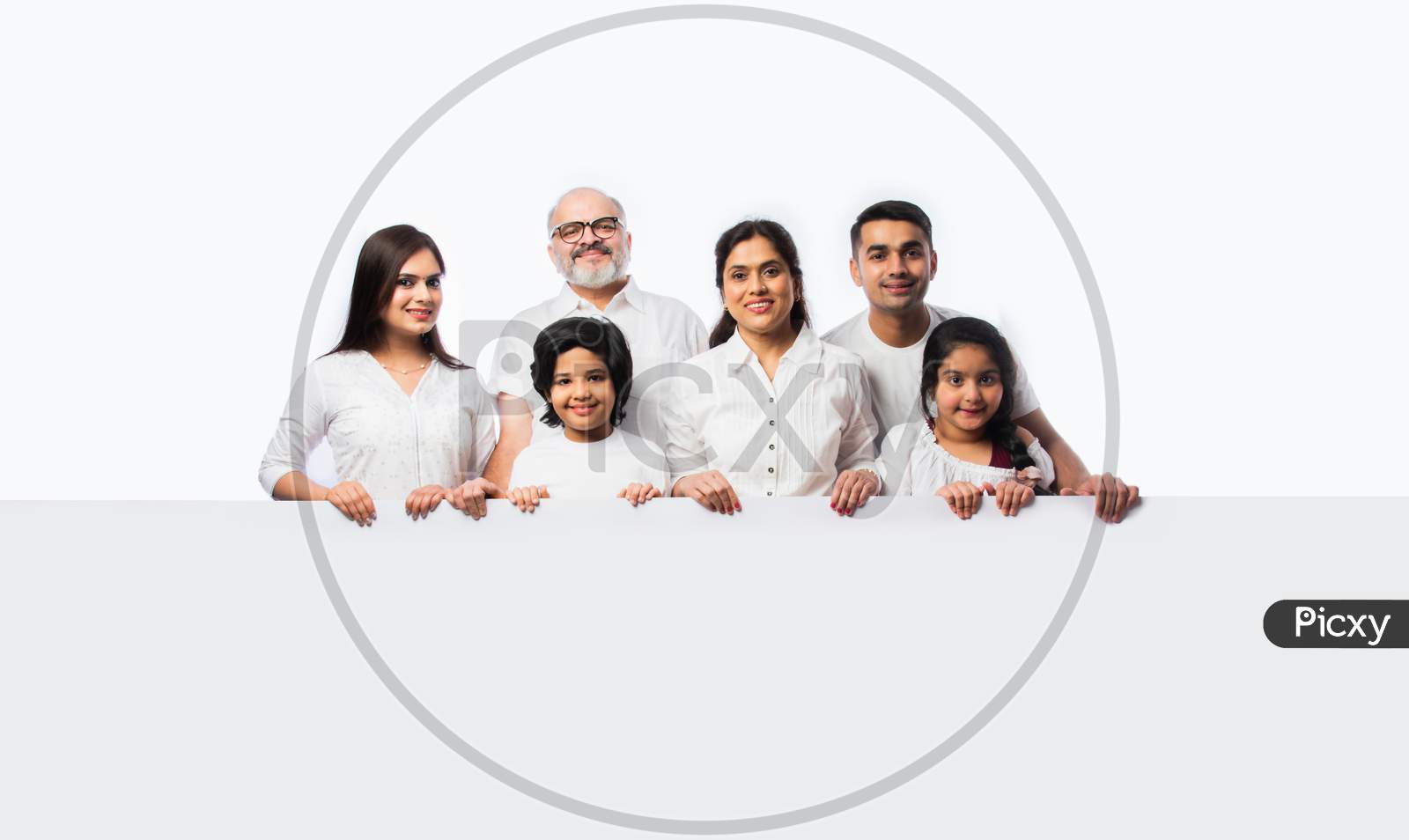 Indian Happy Family Holding Or Presenting White Board, Wall Or Placard