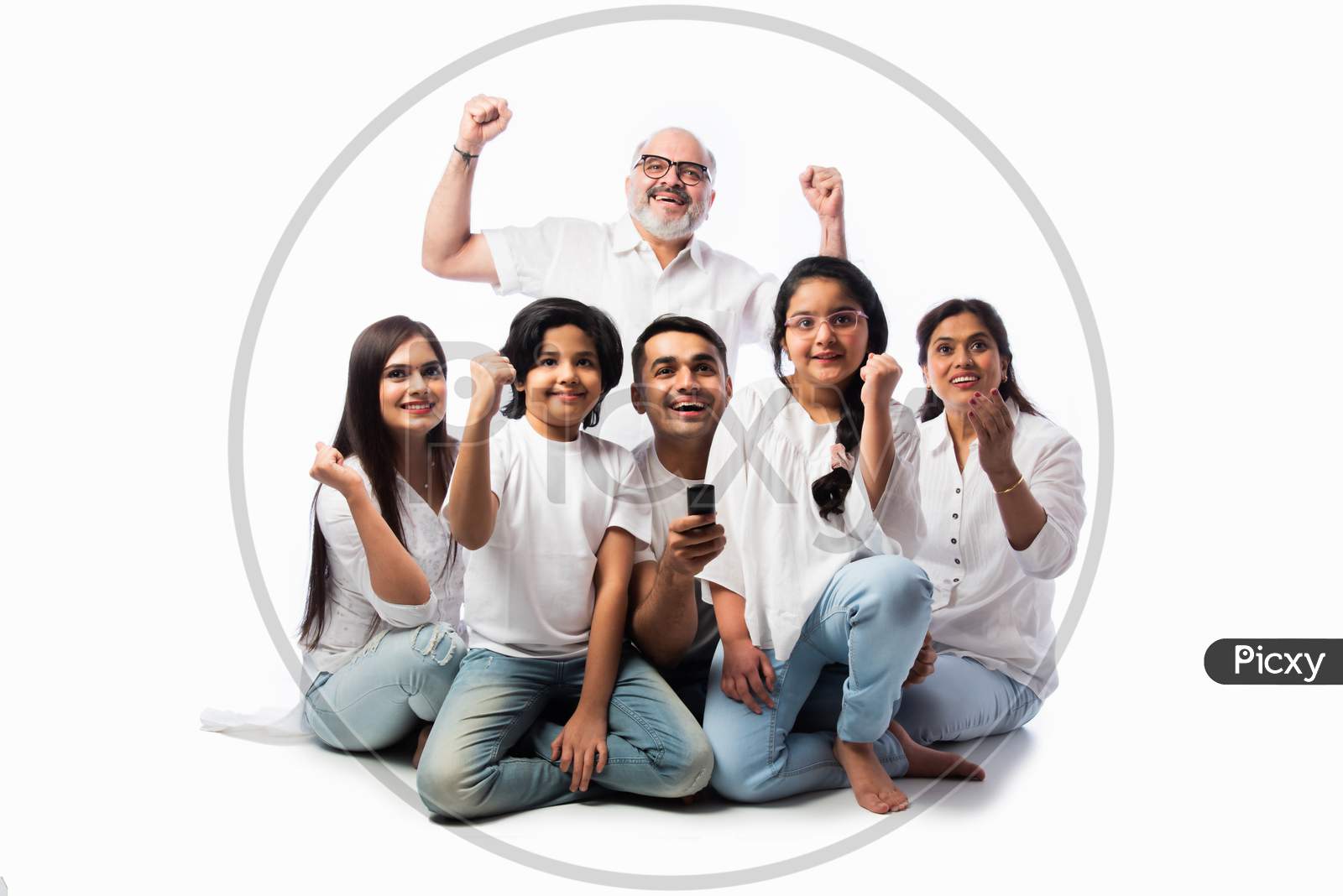 Indian Asian Family Watching Tv, Holding Remote Control, Sitting Against White Background