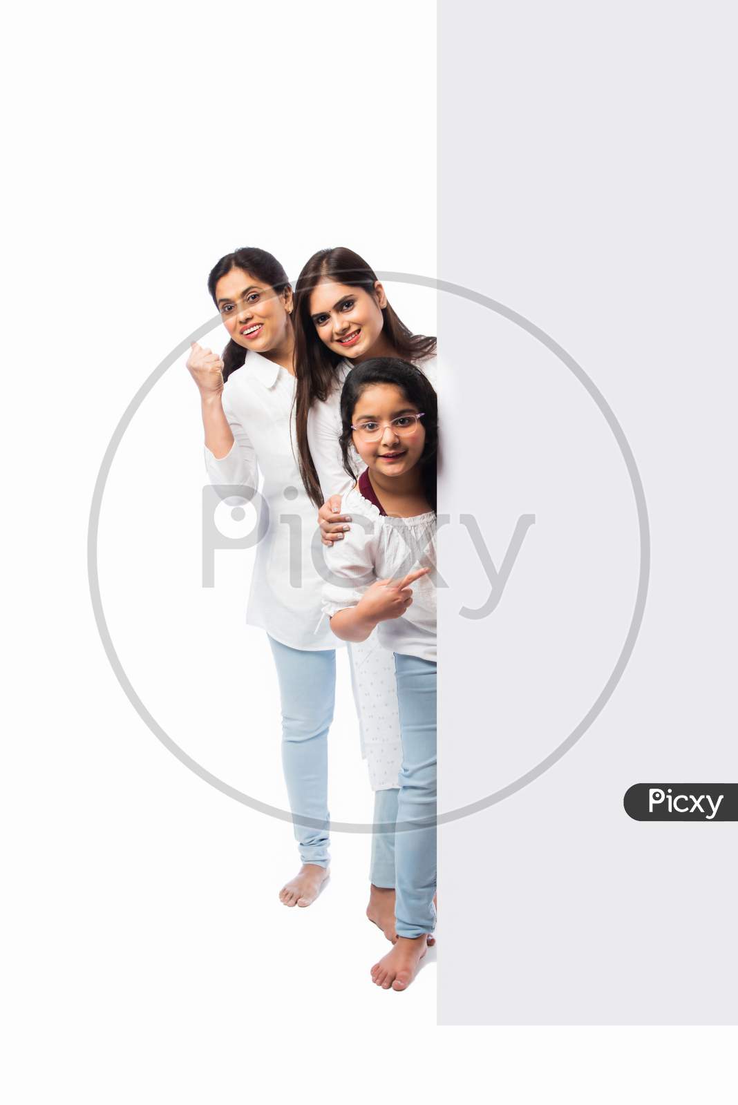 Indian Happy Family Holding Or Presenting White Board, Wall Or Placard