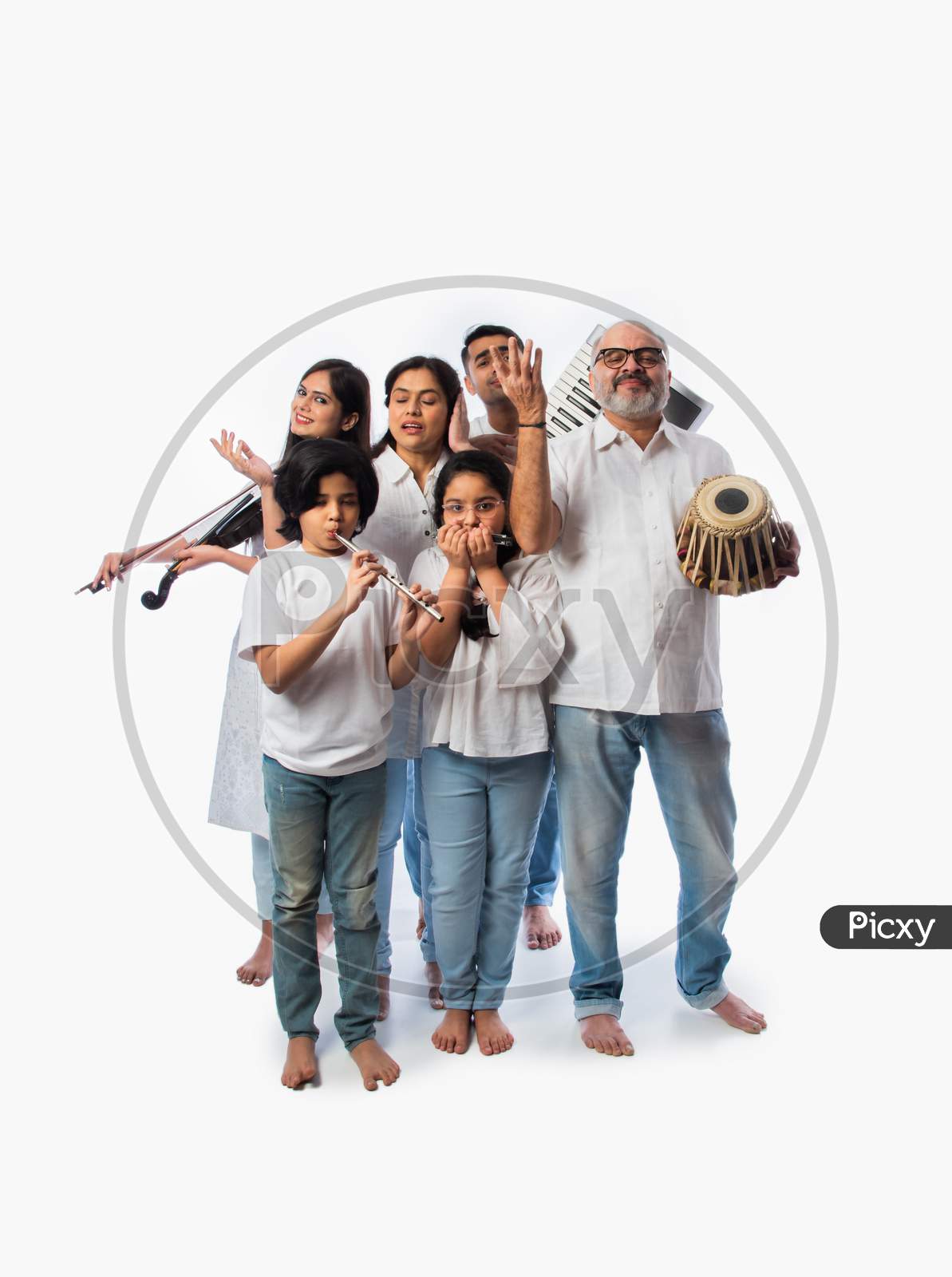 Indian Family Playing Music Instruments Together As A Band, Performing Against White