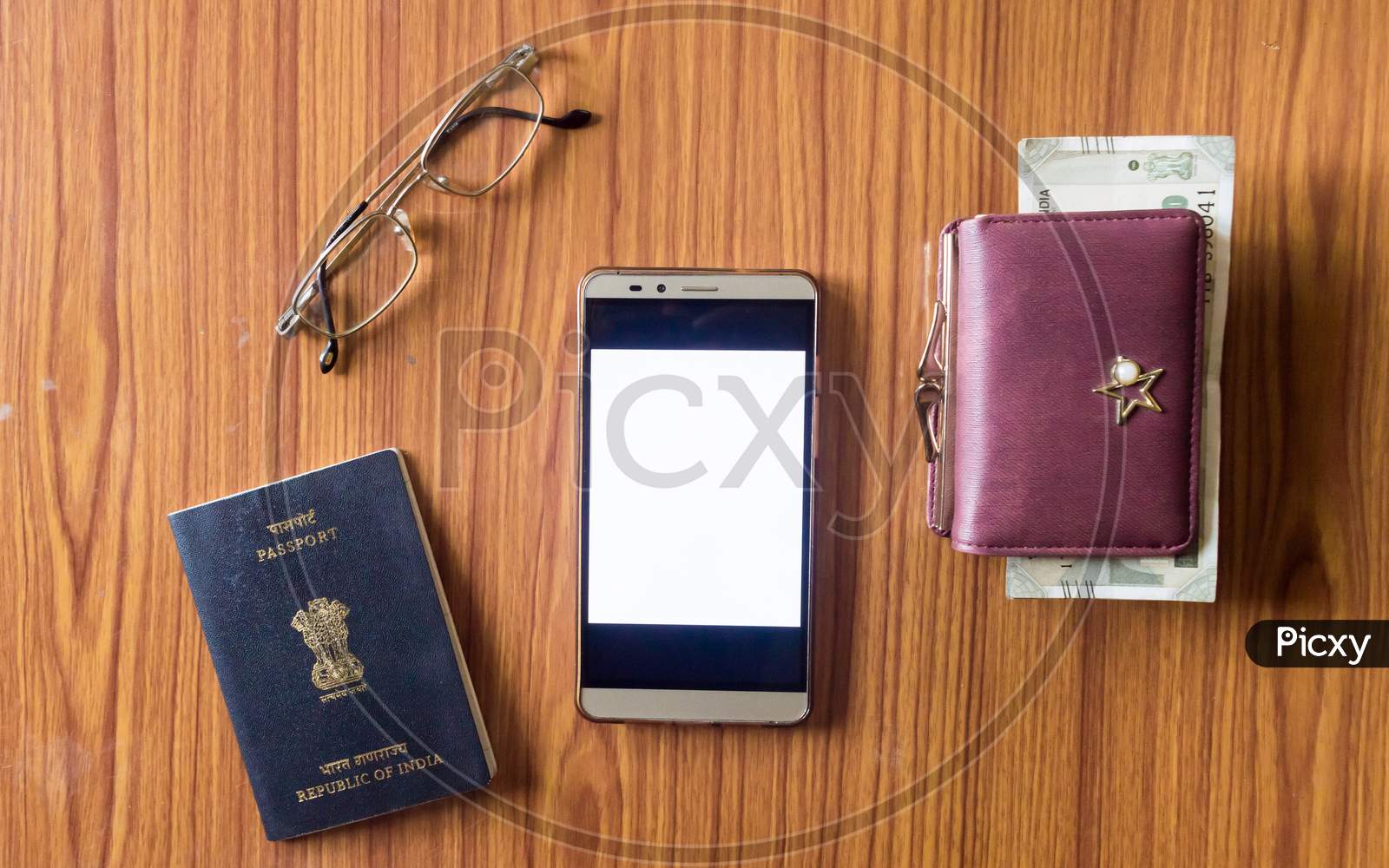 Business Still Life Concept. Personal Accessories On Table Desk. Indian Passport, Money Purse, Paper Currency, Eye Glasses And Mobile Phone With Blank Screen. Top View With Copy Space For Text. Mockup