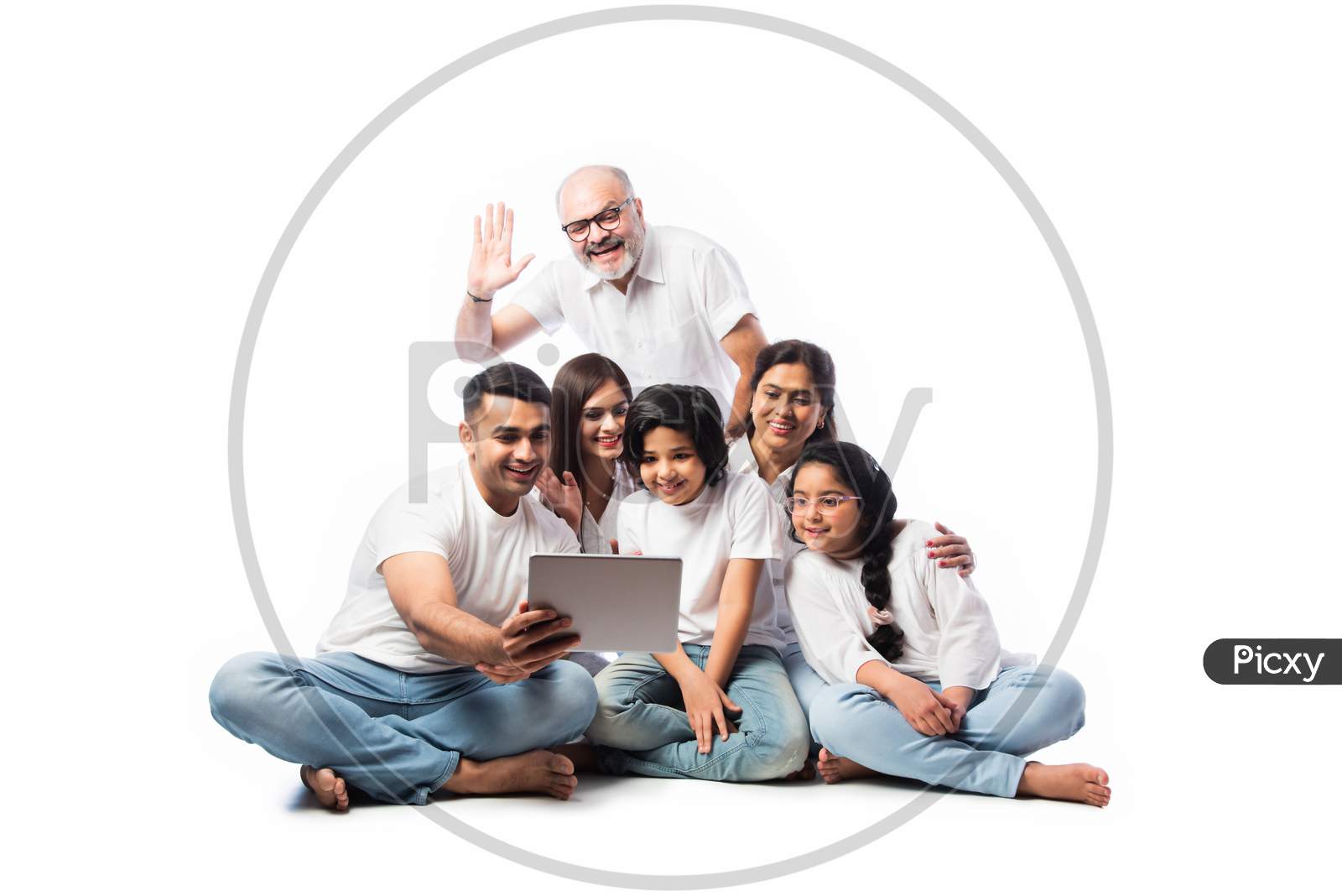Happy Indian Family Shopping Online Using Laptop And Credit Or Debit Card While Sitting Isolated
