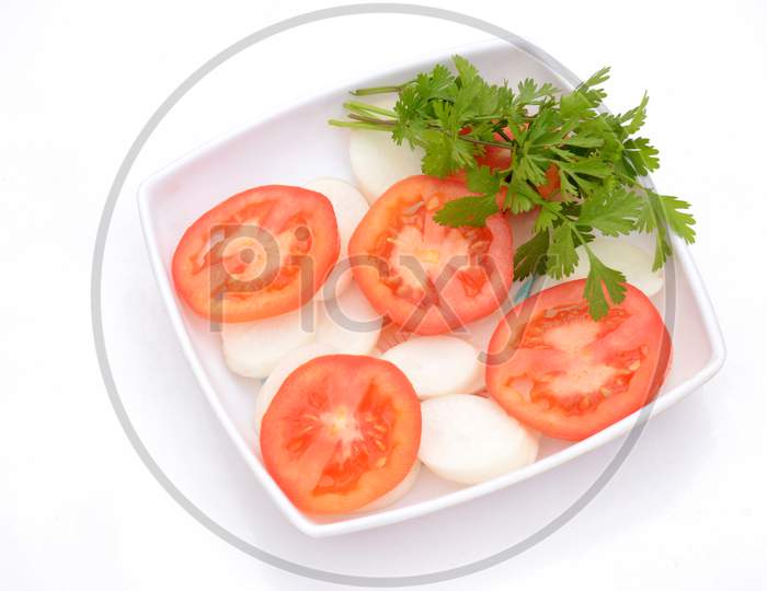The Red Tomato With Radish Sliced And Green Coriander In The Plastic Plate Isolated On White Background.