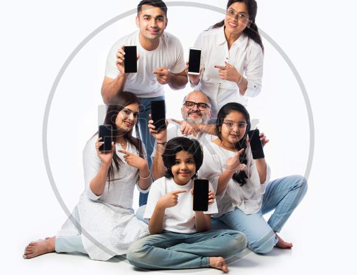 Asian Indian Family Of Six Showing Blank Or Empty Smartphone Screen