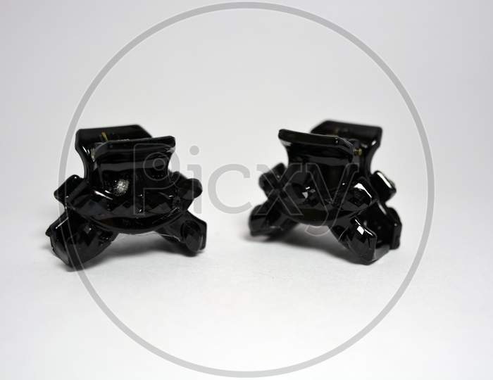 Beautiful and elegant female hair clips, black crabs decorated with black small stones, located on a white background.