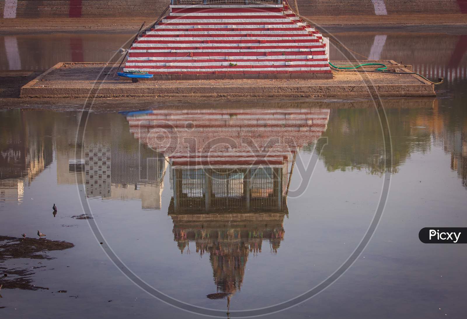 Reflection Of The Temple Tower In The Temple Tank Which Stores Water