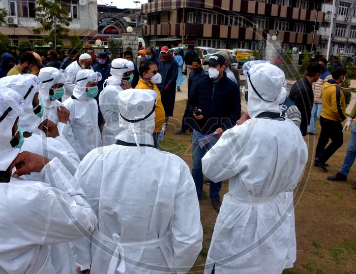 White Dressed Men Sanitizing City In Covid Lockdown.