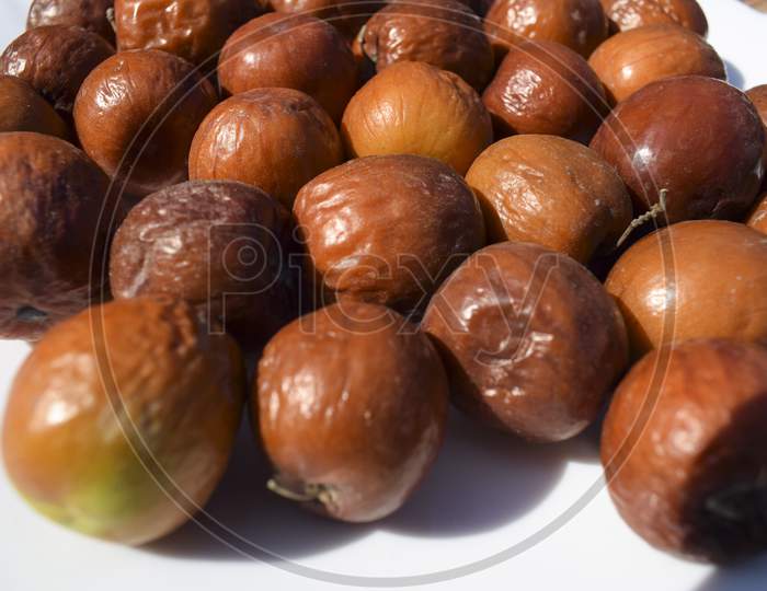 Indian Jujube Fruit, Grown In The Wilds Or Jungle In India, Pakistan, Bangladesh Asian. Closeup Of India Fruit Orange Red Maroon Brown Color.