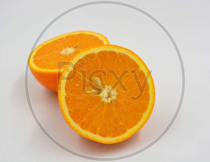 Useful and delicious fruits for human health. Orange oranges cut into two halves. Juicy fresh fades of orange with bones.
