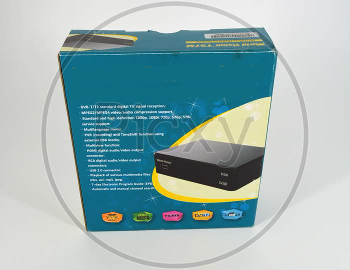 Electronics, black satellite tuner, an antenna prefix with a radio remote control located on a white plastic background.
