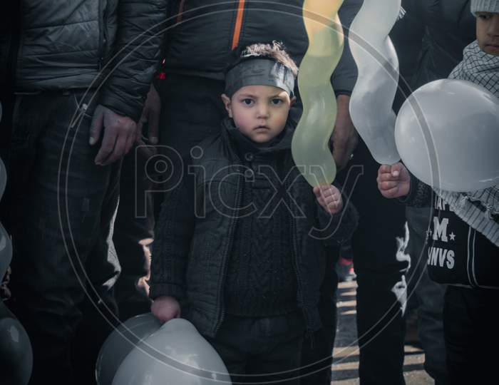 small boy holding baloon