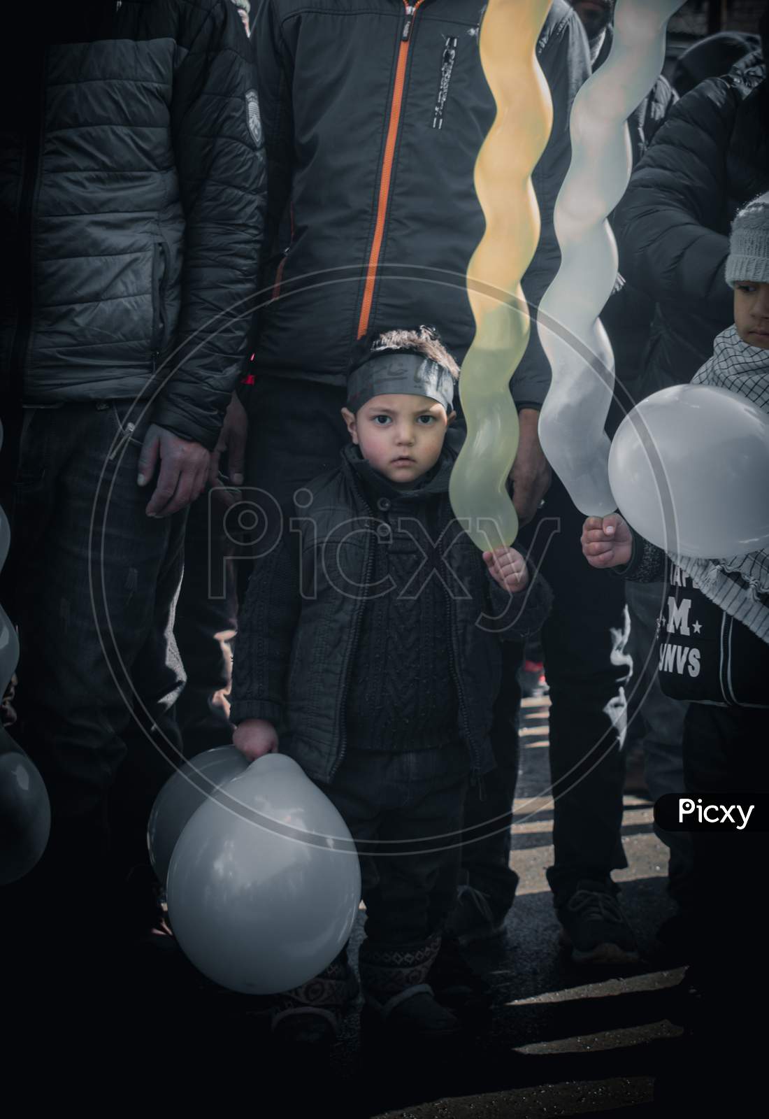 small boy holding baloon