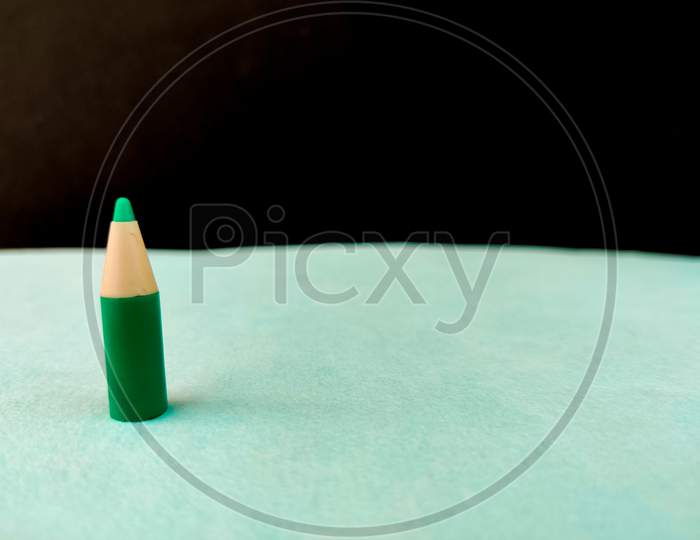 Copy Space Small Size Green Color Pen Or Pencil Or Crayon On Green And Black Background