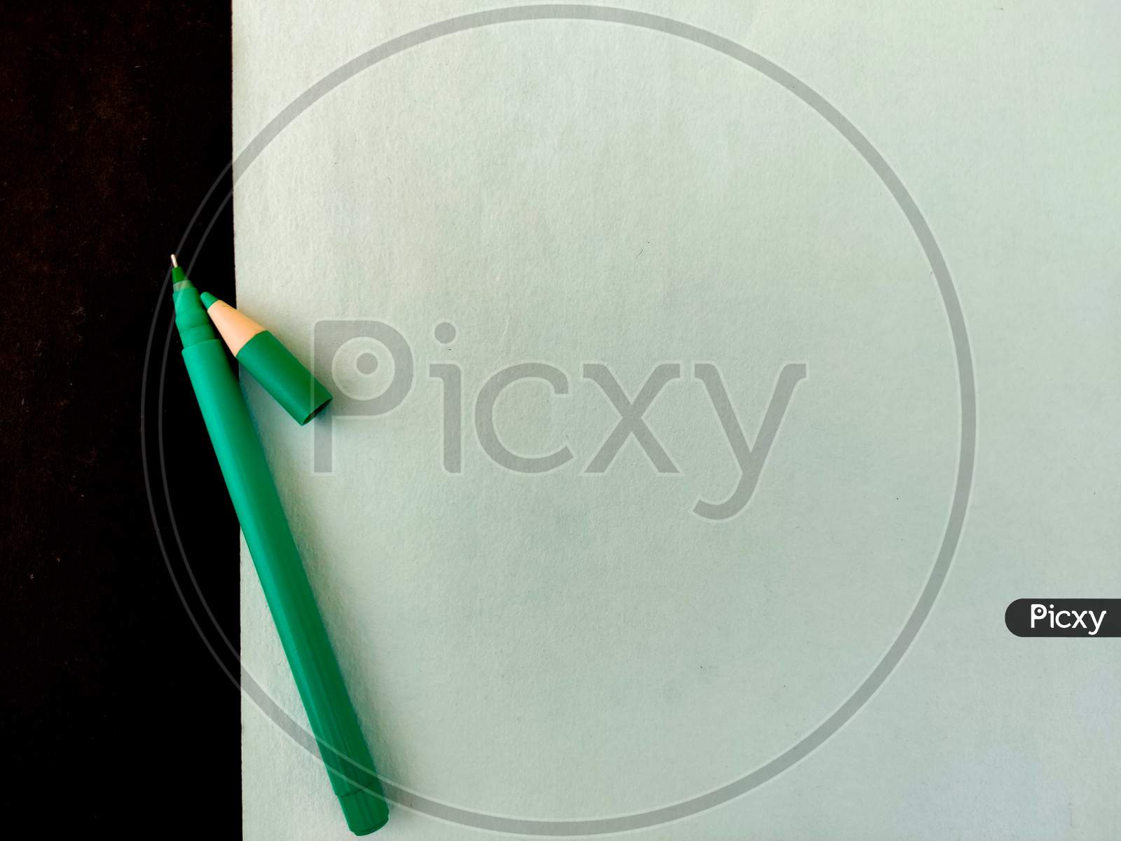 Top View Of Green Ink Pen With Cap Isolated On Green Background
