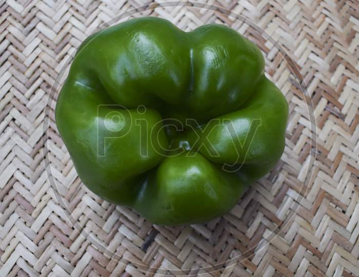 Bottom View Of Green Capsicum Or Green Bellpepper On White Background. Asian Organic Fresh Short Type Of Shimla Mirch Vegetable