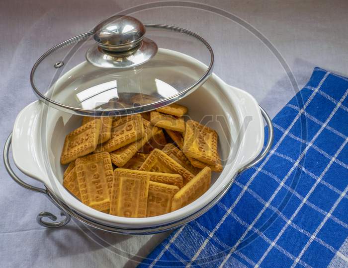 Indian Famous Brown Glucose Biscuit Kept Inside White Glass Bowl.