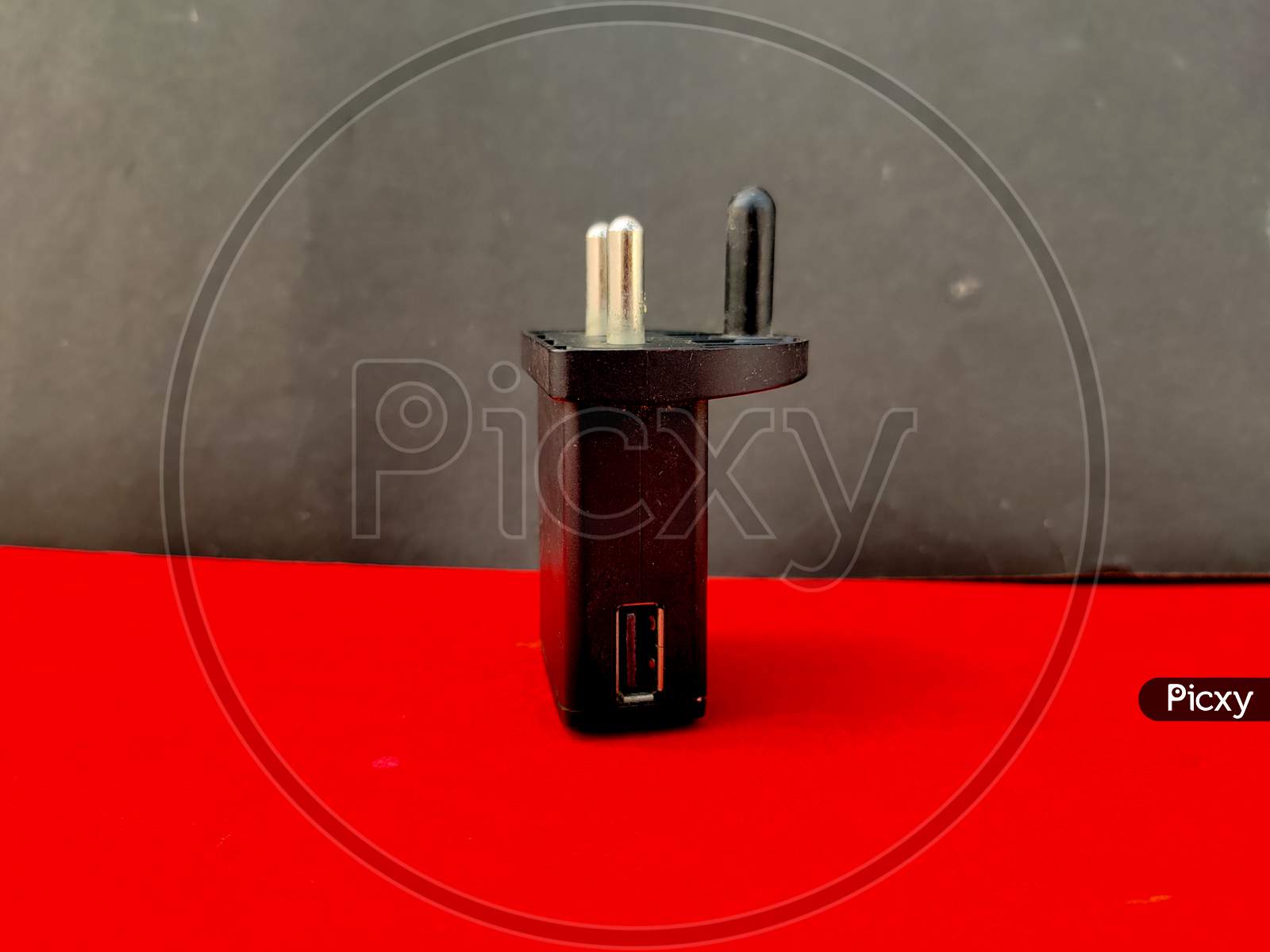 Black Color Usb Phone Charger On Red And Black Background