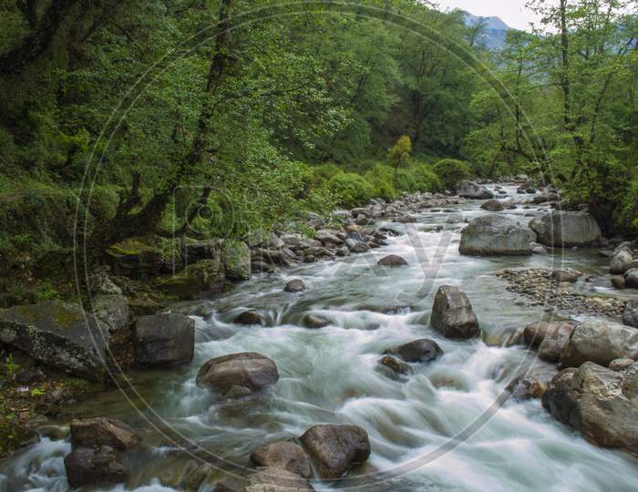 A Beautiful Mountain River Balkhila Flowing Through Rocks And Forest In A Small Village.