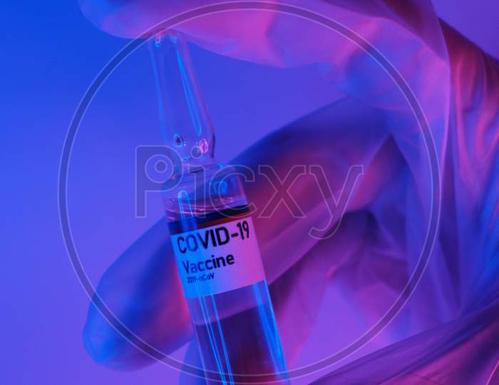 Doctor demonstrating dose of Vaccine against corona Virus in Laboratory