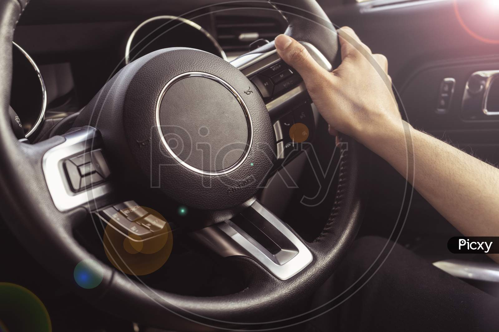 Close Up Of Hands Holding The Steering Wheel Of A Car. Interior Of A Luxury Car.