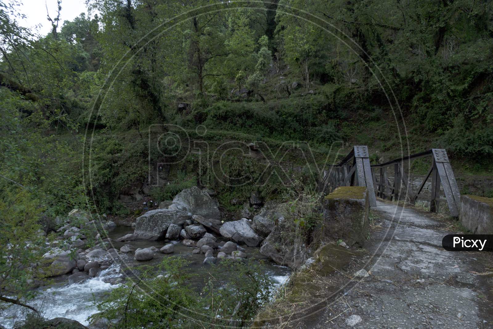 A Nice Landscape Of Rapid Mountain River Balkhila Flowing Under A Bridge In A Small Village.