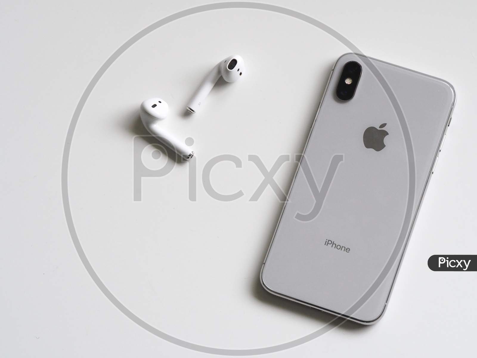 Silver Phone X with Airpods