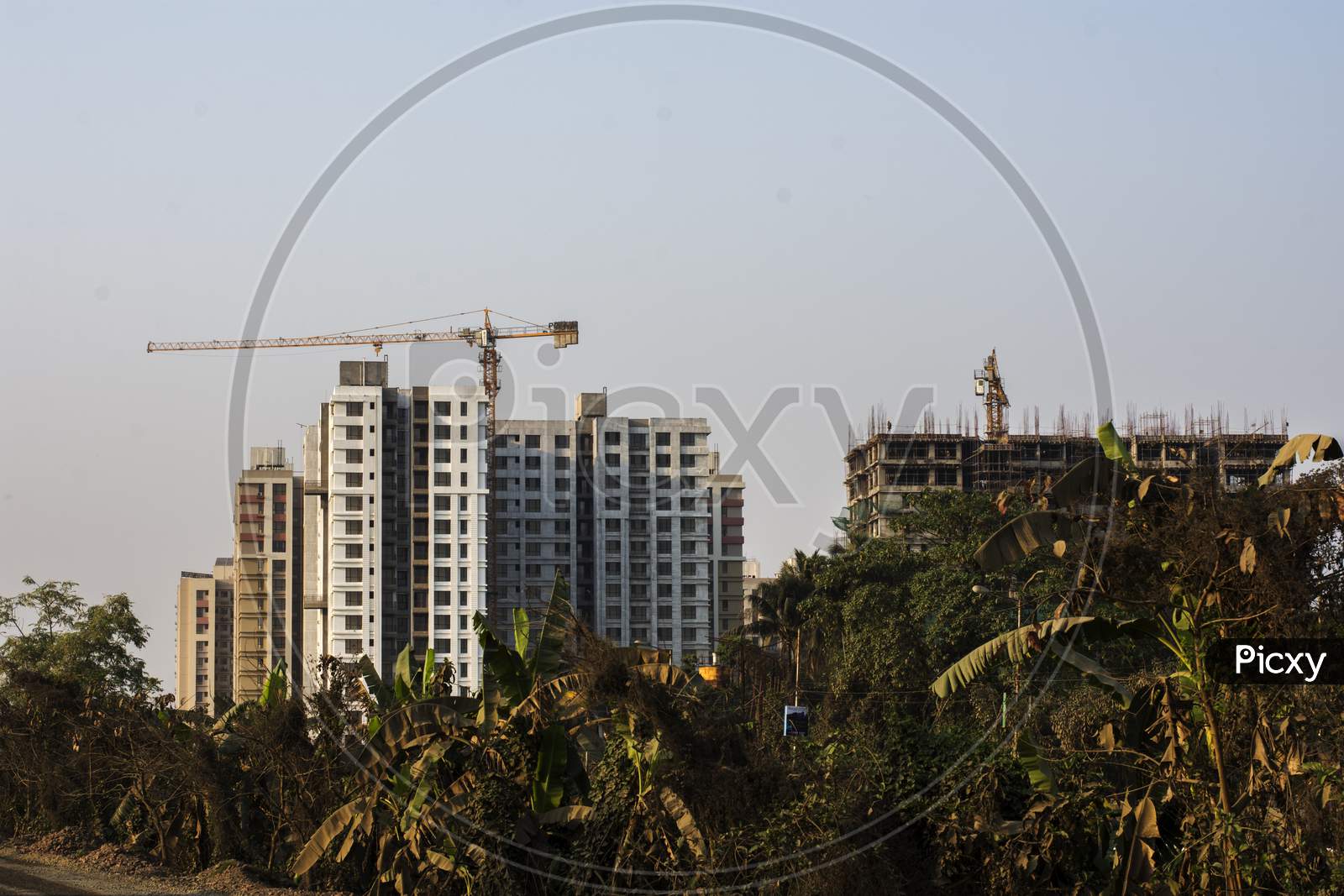 A Highrise Residential Building Under Construction In A Sunny Day.