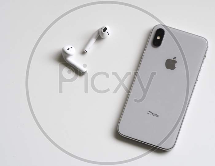 Silver Phone X with Airpods