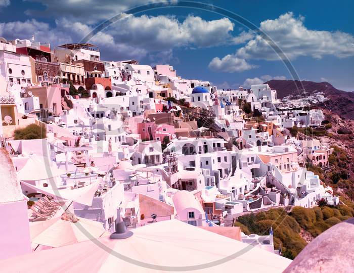 Santorini, Greece - September 11, 2017: Wide Angle Cityscape Of White Houses And Blue Domes Of The Churches Dominate The Aegean Sea, Oia, Island Of Santorini, Cyclades, Greek Islands, Europe