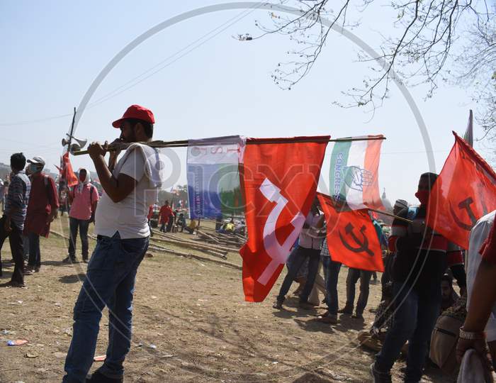 Left supporter at the Kolkata Maidan holding red flag and congress flag as the united opposition holds historic mega rally