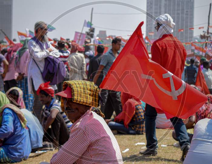 Left supporter bearing red communist flag looks on as the united left in west bengal gears for mega rally