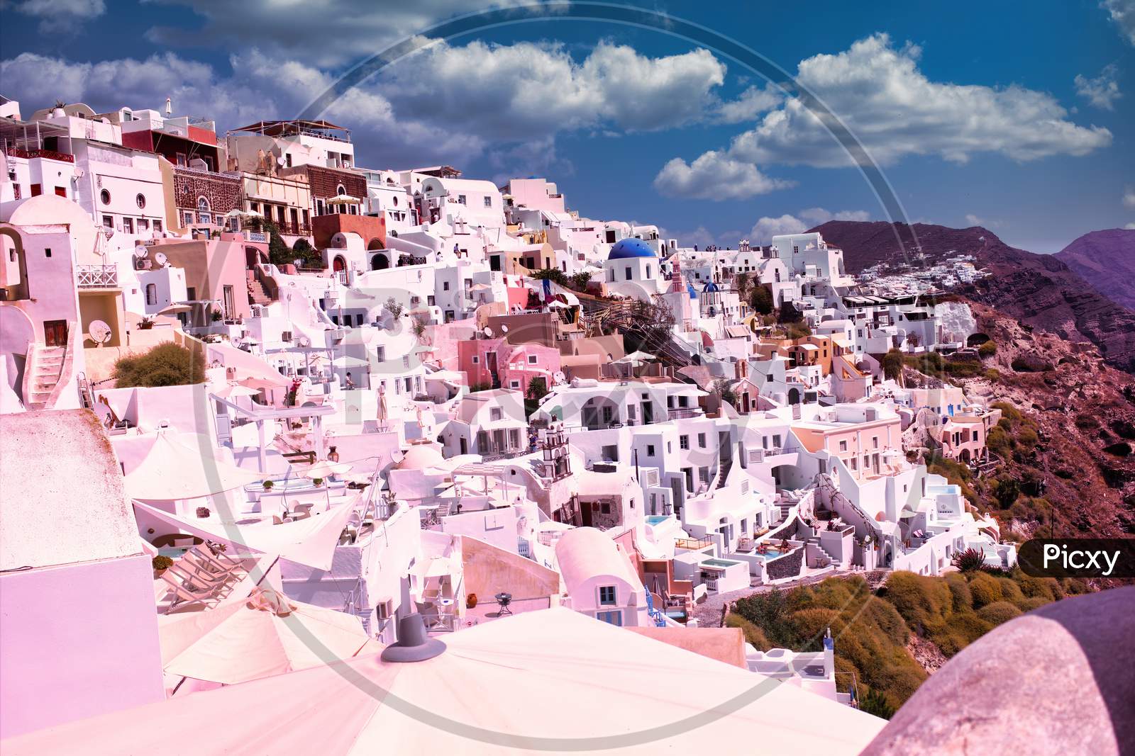 Santorini, Greece Beautiful city of Oia on a hill of white houses with blue  roof against dramatic pink sky, located in Greek Cyclades islands in Mediterranean  sea Photograph by Arpan Bhatia 